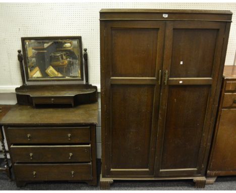 An early-20th Century oak dressing chest, bevelled mirror above a single drawer, overhanging top above three long drawers, br