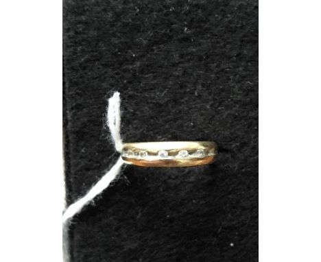 A yellow precious metal band (possibly 18ct Continental) set with seven faux diamonds. Size K. Approximate weight 3.7 grams.