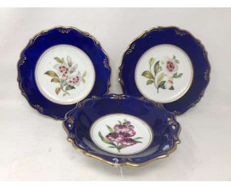 A 19th Century hand painted cobalt blue and gilt decorated fruit bowl and two matching plates, the wells decorated with botan