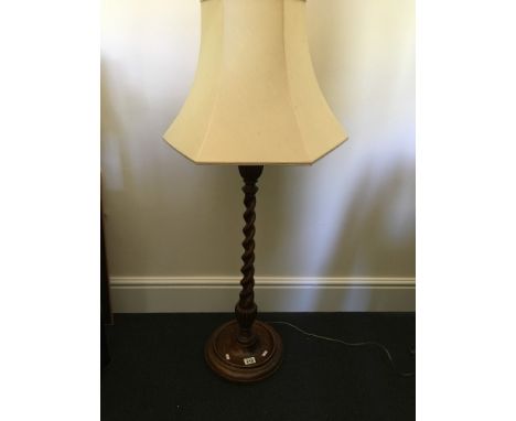 A 1930s /40s oak three-quarter barley twist standard lamp with shade and an oak three tiered folding cake stand.