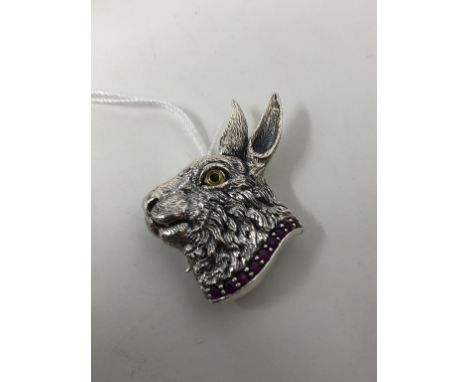 An unusual sterling silver pendant/brooch in the form of a hare wearing a ruby collar.