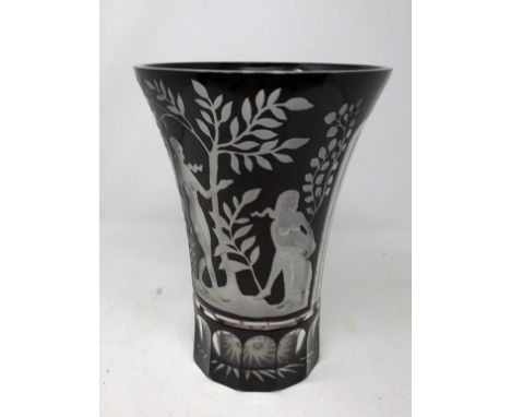 An etched ruby vase decorated with naked maidens.
