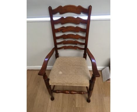 Eight ladder back dining chairs with over-stuffed seats.