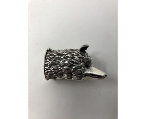 A silver vesta case in the form of a fox head with ruby eyes.