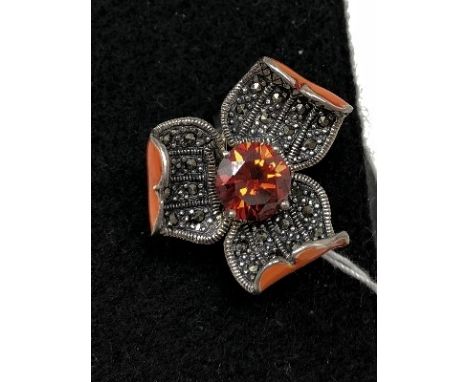 An unusual silver, marcasite and enamel dress ring with central topaz style stone in the form of a flower. Size P.