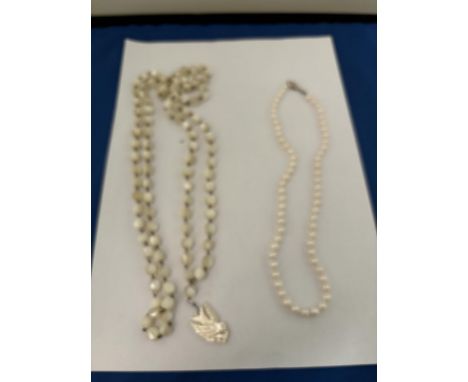 TWO PEARL NECKLACES TO INCLUDE ONE WITH A BIRD PENDANT THE OTHER WITH A MARKED SILVER CLASP