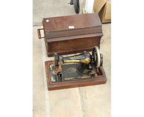 A VINTAGE SINGER SEWING MACHINE WITH WOODEN CARRY CASE