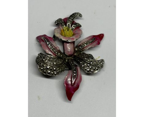 A VINTAGE ENAMELLED AND MARCASITE SET ORCHID DESIGN BROOCH
