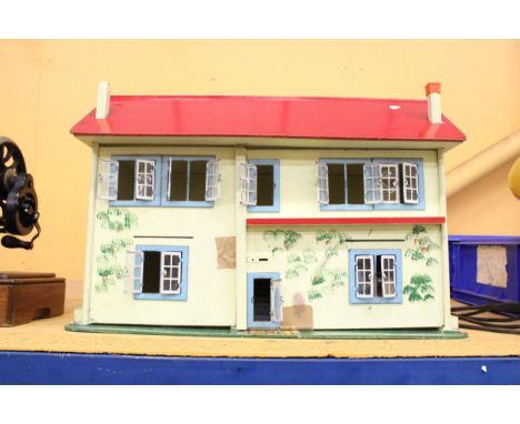A VINTAGE DOLLS HOUSE CONTAINING A LARGE QUANTITY OF FURNITURE
