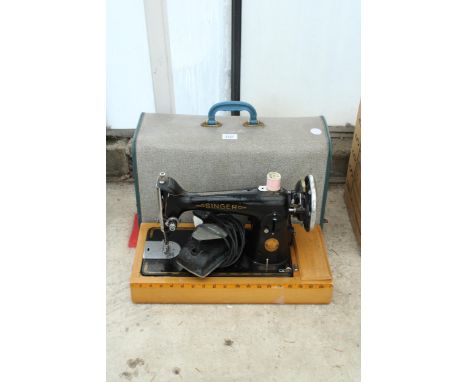 A VINTAGE ELECTRIC SINGER SEWING MACHINE WITH FOOT PEDAL AND CARRY CASE