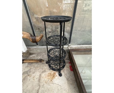 A VINTAGE FOUR TIER METAL PAN STAND WITH LION PAW FEET