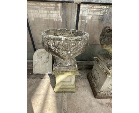 A CONCRETE URN PLANTER ON A CONCRETE PEDESTAL BASE