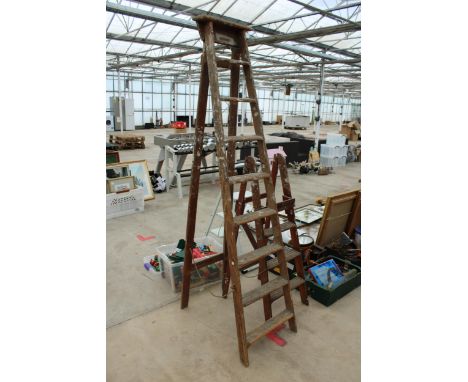 AN EIGHT RUNG VINTAGE WOODEN STEP LADDER AND A FURTHER THREE RUNG WOODEN STEP LADDER