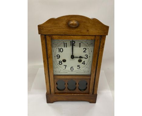 A CARVED WOOD CASED GERMAN 8 DAY STRIKING MANTLE CLOCK WITH KEY AND PENDULUM