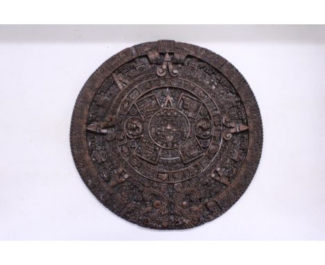 AN ORNAMENTAL AZTEC EMBOSSED WALL PLAQUE