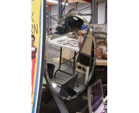 A VINTAGE OVAL FRAMELESS MIRROR WITH BEVELLED GLASS AND DECORATION TO THE TOP AND BOTTOM, 33CM X 61CM