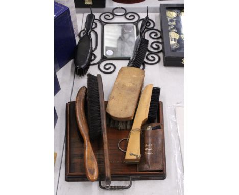 A VINTAGE WROUGHT IRON FRAMED MIRROR WITH SHOE SHINE GROOMING BRUSHES TOGETHER WITH FURTHER BRUSHES, ETC.,