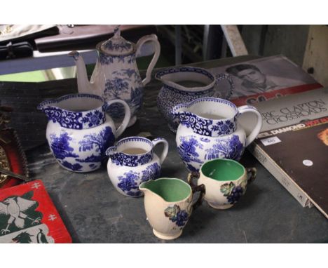 FIVE PIECES OF BLUE AND WHITE POTTERY TO INCLUDE FOUR JUGS AND A COFFEE POT, PLUS A CARLTON WARE JUG AND SUGAR BOWL