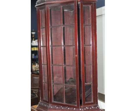 PAIR OF EARLY 20TH CENTURY OAK CORNER CABINETS
with shaped pediment, the astragal glazed door opening to reveal interior shel