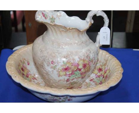 LATE VICTORIAN MOULDED EWER AND BASIN
decorated with floral motifs and with gilt highlights, repair to the rim of the ewer, s