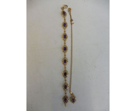 An Art Nouveau style 9ct gold and amethyst inset bracelet plus a 9ct gold and amethyst inset pendant. 