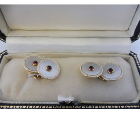 A cased pair of 18ct gold and ruby inset mother of pearl and enamel cufflinks.