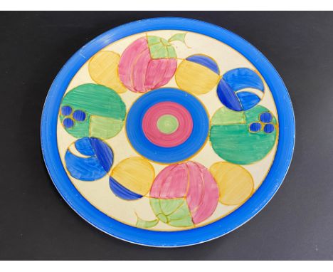 A Clarice Cliff for Wilkinson Ltd. circular plate, circa 1930s decorated with stylised oval pink fruit within a blue border, 