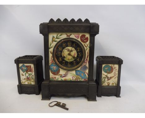 An Edwardian slate mantle clock and two matching square vases, all inset with porcelain plaques decorated with ducks and bird