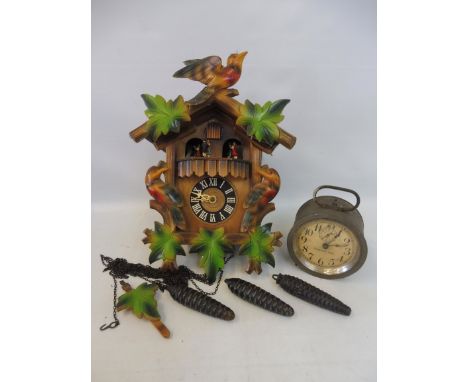 A cuckoo clock and an alarm clock. 