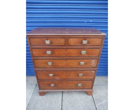 A George III oak and mahogany crossbanded chest of two short over four long drawers, in two parts, raised upon bracket feet, 