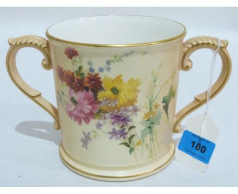 A Royal Worcester loving cup, painted to either side with wild flower sprays in coloured enamels on a blush ivory ground and 