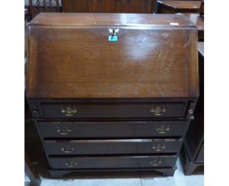Reprodux Furniture. An oak bureau with four long graduated drawers, raised on bracket feet. 33' wide 