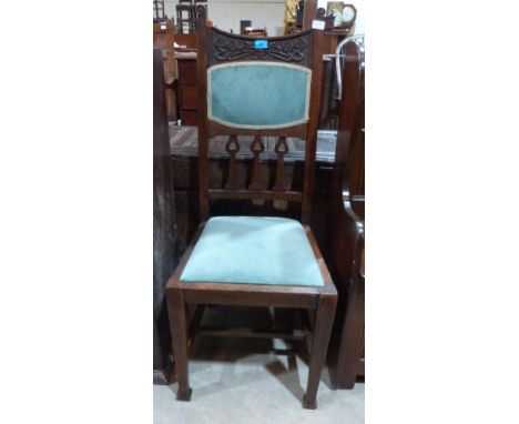 An early 20th century oak side chair with Art-Nouveau influenced carved back