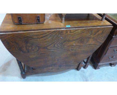 An elm gateleg dining table on ring turned legs. 42' wide