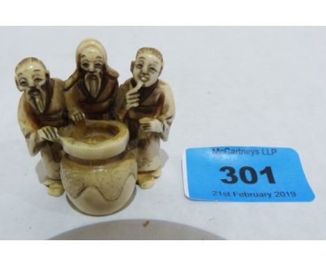 A Japanese carved ivory netsuke, three wise men with pot. Meiji. Signed
