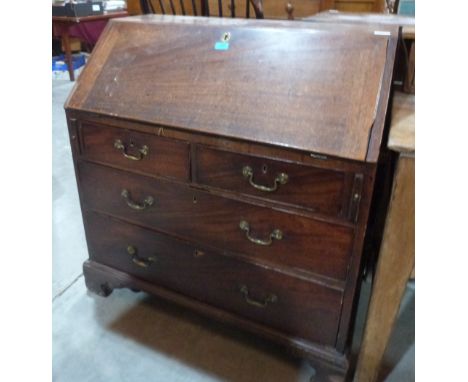 A George III mahogany bureau, the sloping fall over two short and two long drawers, on ogee bracket feet. 36' wide