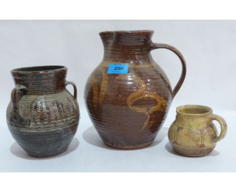 Michael Cardew 1901-1983. Winchcombe Pottery. A jug slip decorated with birds and reeds, 9½' high, a small jug and a three ha