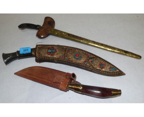 A Gurkha kukri knife, the scabbard with applied scrolled wirework and headstones, 17' long; a kris knife with brass scabbard 