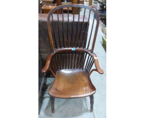 A 19th century oak, fruitwood and elm Windsor elbow chair on ring turned legs