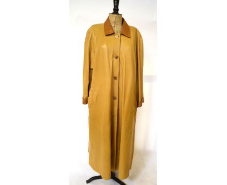 A pale sand-coloured soft leather full length lady's coat with tan collar and cuffs and oatmeal silk lining, 62 cm across che