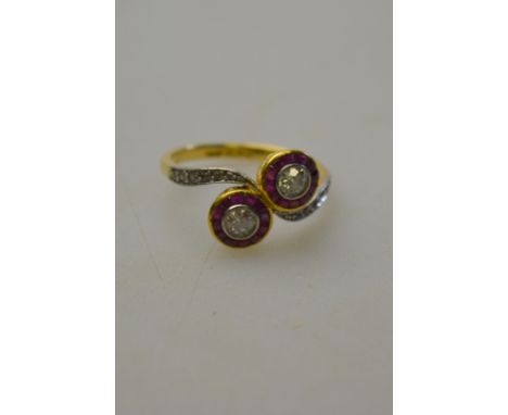 Diamond and baguette ruby crossover ring with diamond set shoulders, 18ct yellow gold and platinum set, size O 1/2