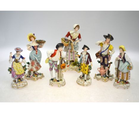 Seven various porcelain figures, comprising: a girl with a rabbit; and three male and female pairs of figures; two of the pai