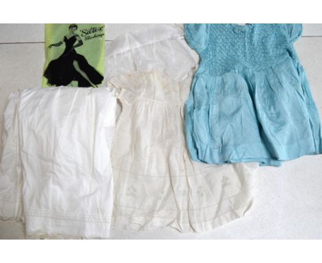 A box containing a collection of cotton Victorian infants' gowns, two later dresses (an embroidered organza dress and a smock