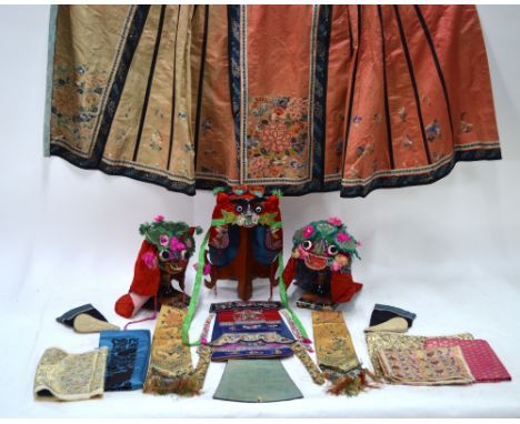 A Chinese embroidered skirt, other Chinese and other textiles to include: two ceremonial embroidered hats; a collection of co