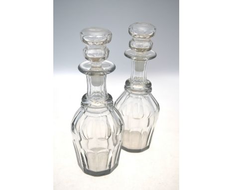 A pair of glass decanters and stoppers; each decanter with trumpet neck and oviform, faceted body, 27cm high, 19th Century (2