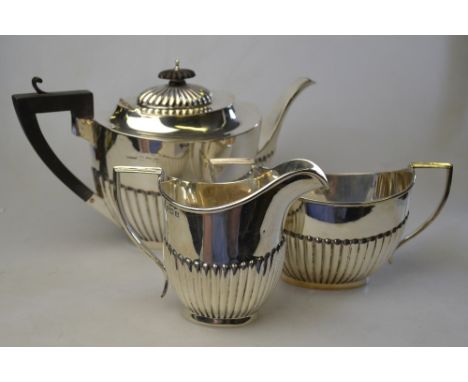 An oval half-reeded silver three-piece tea service, H V Pithey & Co, Birmingham 1911/12, 27.5 oz total