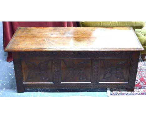 A late 17th/18th century oak coffer, the wide two plank top over a twin panel front, on short stile feet, 126 x 54 x 50 cm