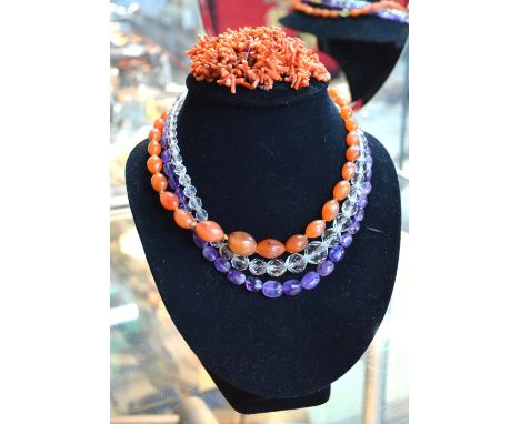 A row of graduated tumbled amethyst beads, graduated cornelian beads, facetted glass and quantity of stick coral beads to/w a