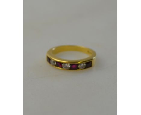 Ruby and diamond seven stone half eternity ring, four oval rubies and three diamonds, channel set, 18ct yellow gold, size N 1