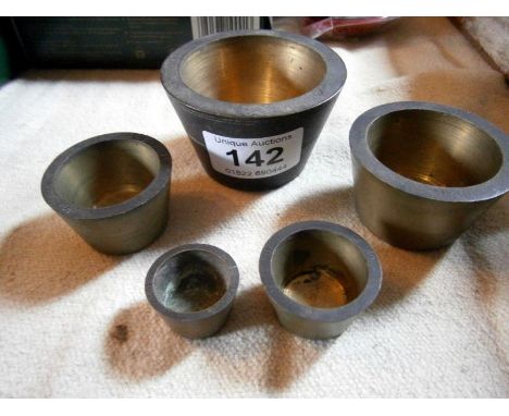 A set of 5 graduated bronze tray measures